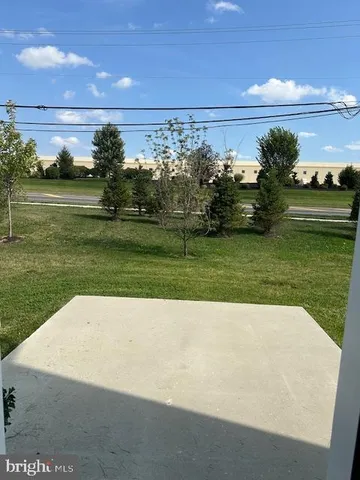 a view of outdoor space with garden and lots of trees in the background