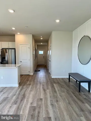 a view of a room with wooden floor and furniture