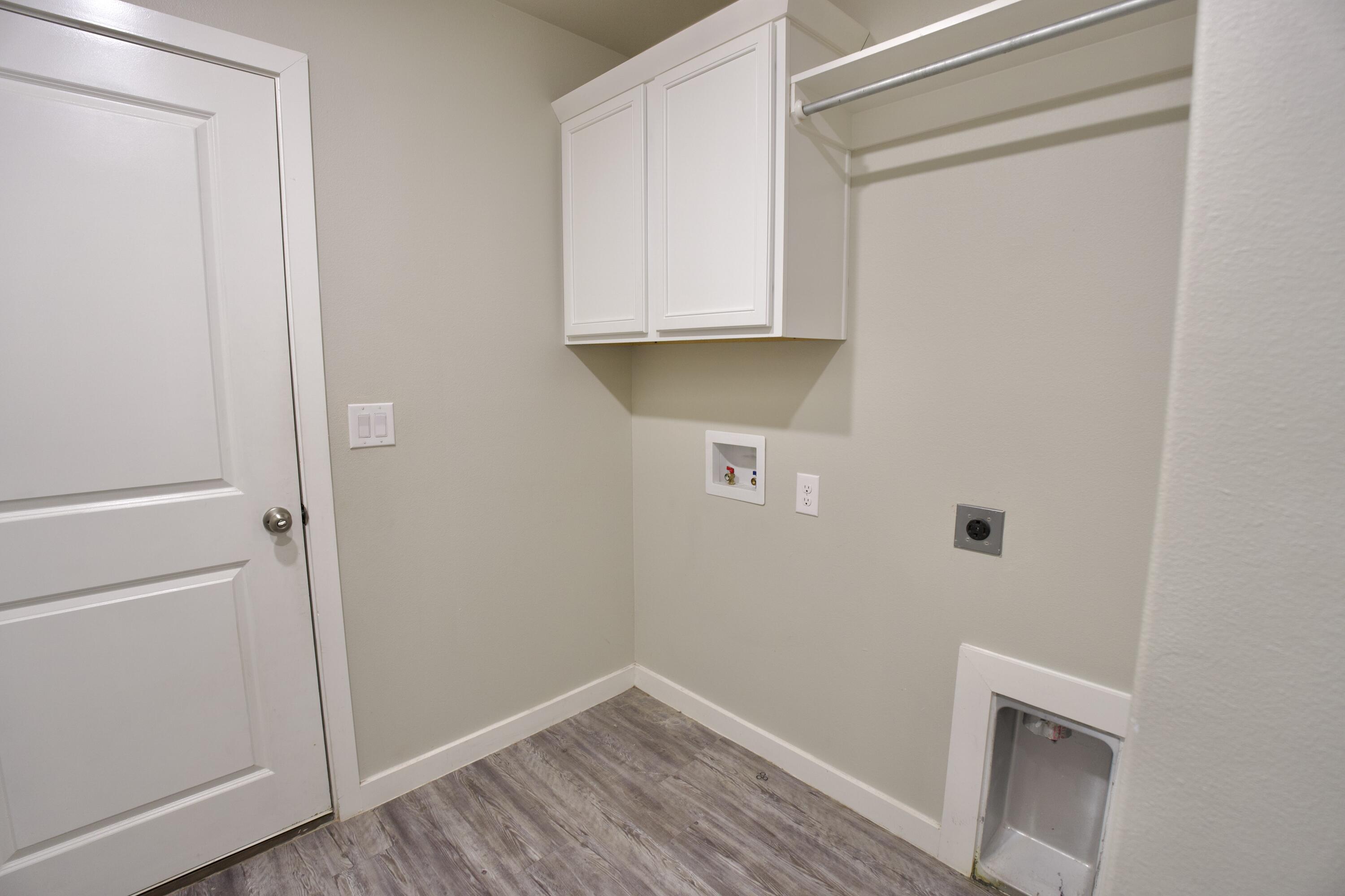 1604 137th Street Lubbock, TX 79423 - Photo 17 of 19 a view of an empty room with wooden floor