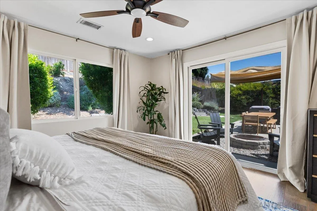 12243 Buckskin Trail Poway, CA 92064 - Photo 32 of 41 a bedroom with a large bed and a large window
