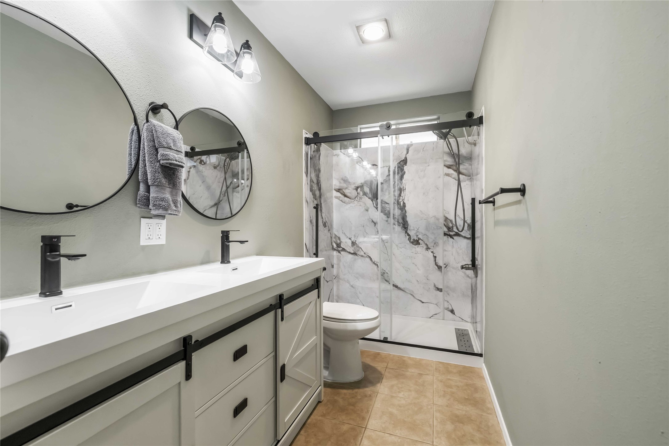 1703 Waterloo Trail, Unit B Austin, TX 78704 - Photo 19 of 36 Bathroom featuring double vanity, a marble finish shower, and light tile patterned floors
