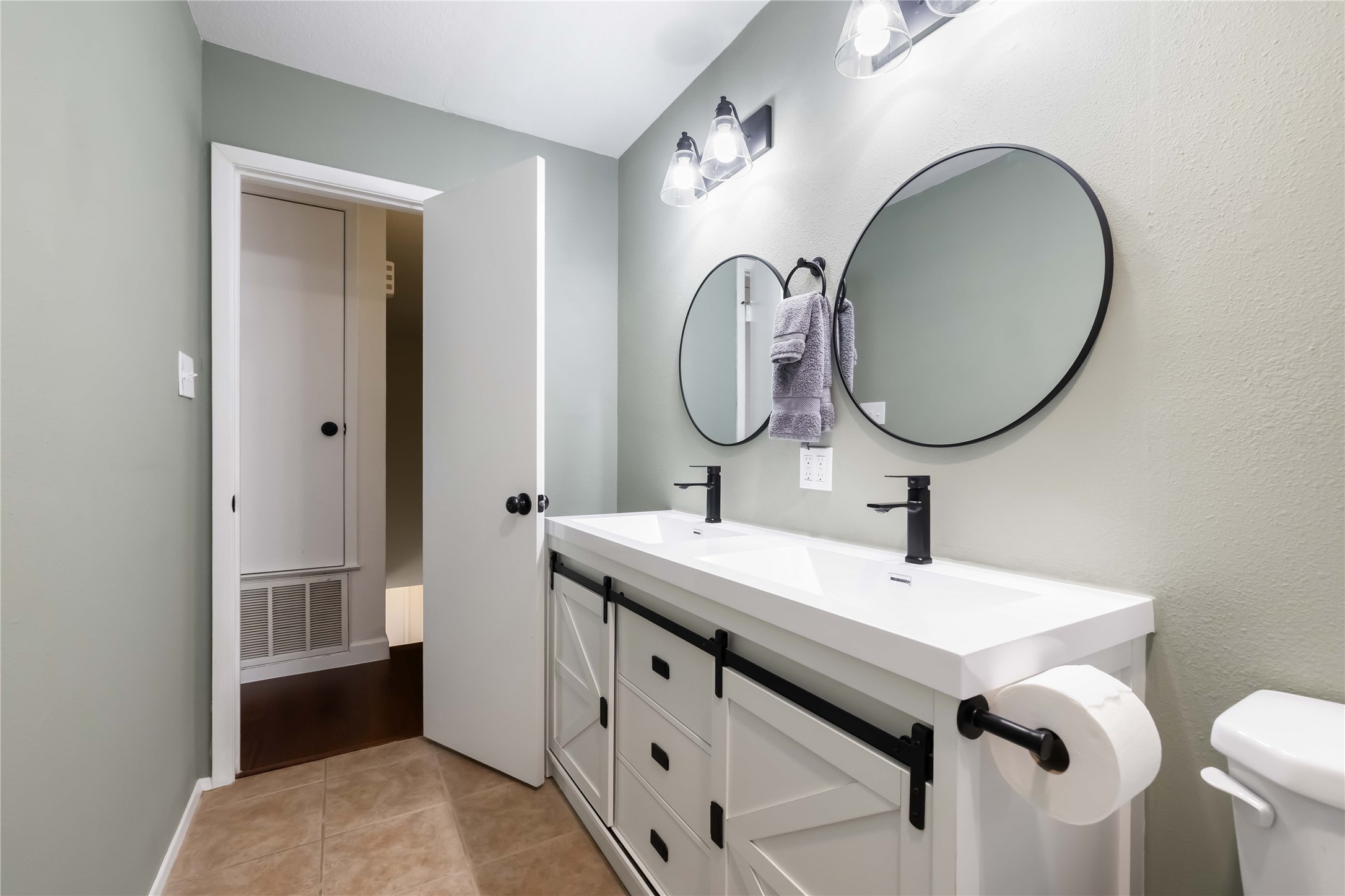 1703 Waterloo Trail, Unit B Austin, TX 78704 - Photo 20 of 36 Bathroom with double vanity and light tile patterned floors