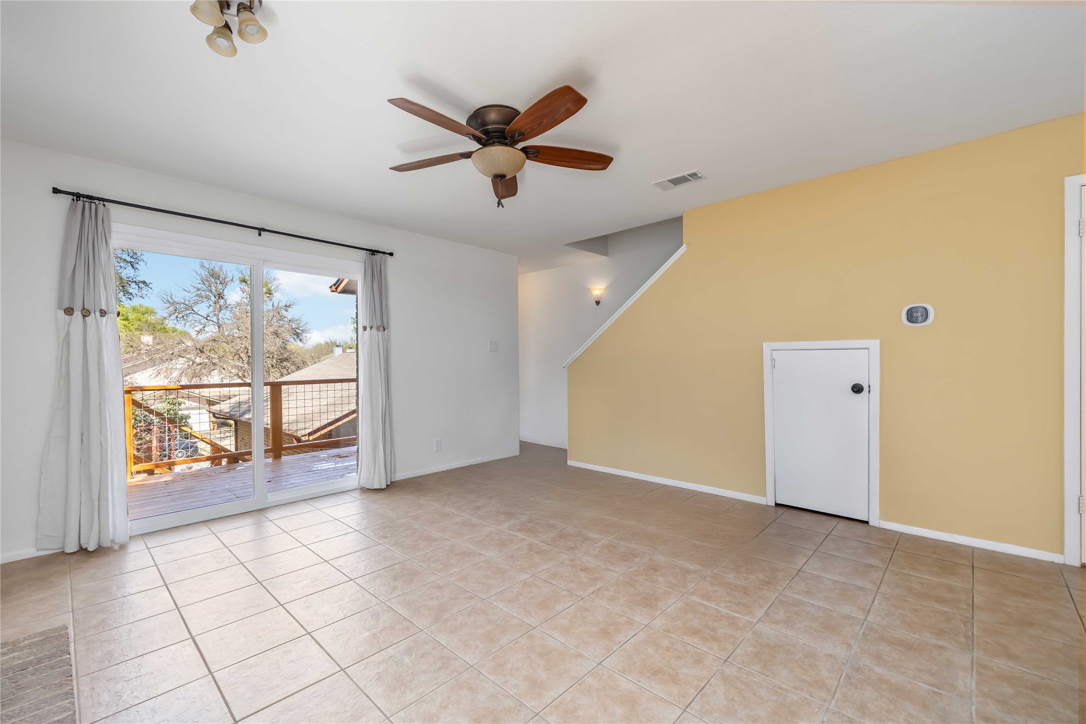1703 Waterloo Trail, Unit B Austin, TX 78704 - Photo 2 of 36 Empty room featuring a ceiling fan and light tile patterned flooring