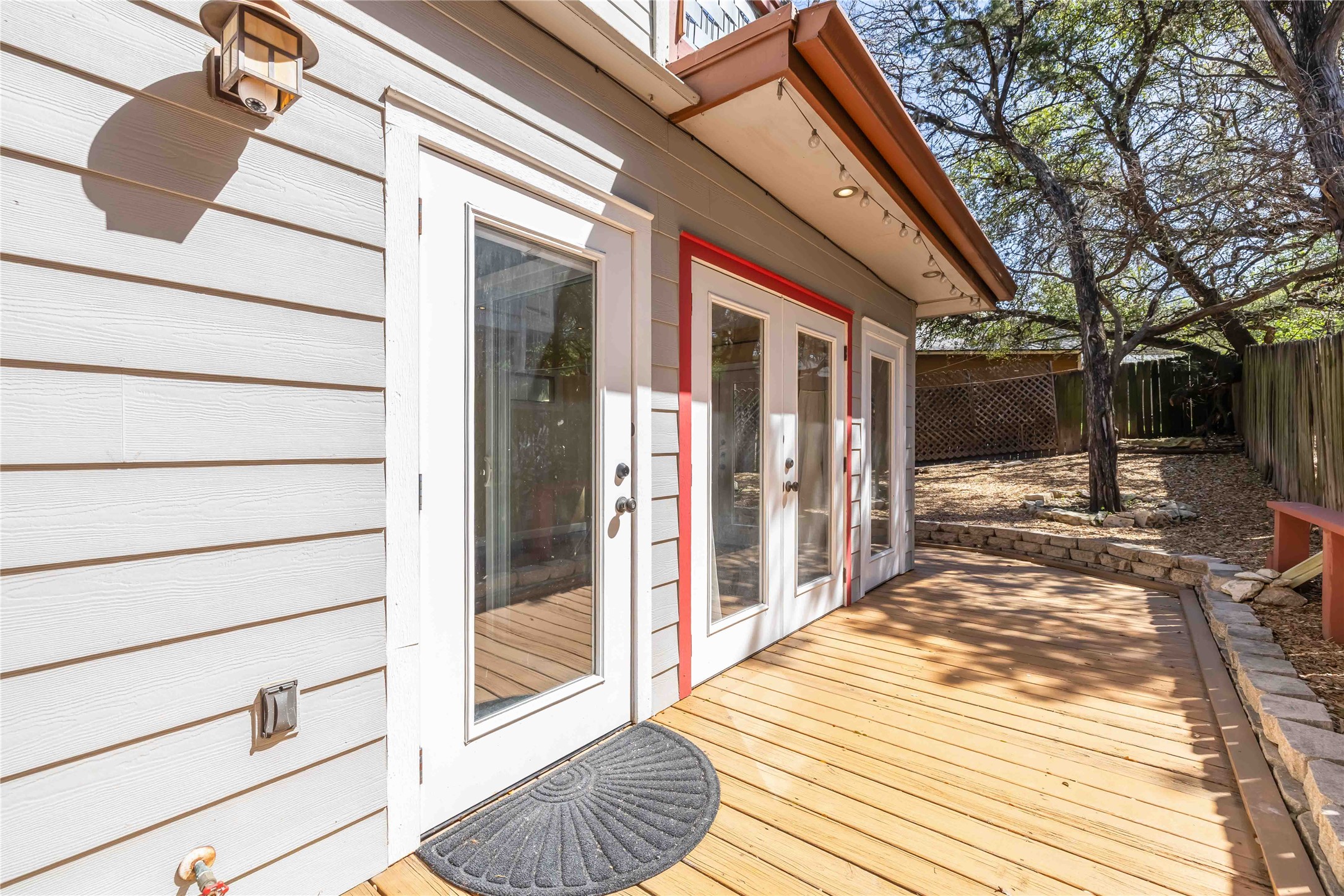 1703 Waterloo Trail, Unit B Austin, TX 78704 - Photo 26 of 36 Wooden terrace with a fenced backyard and french doors