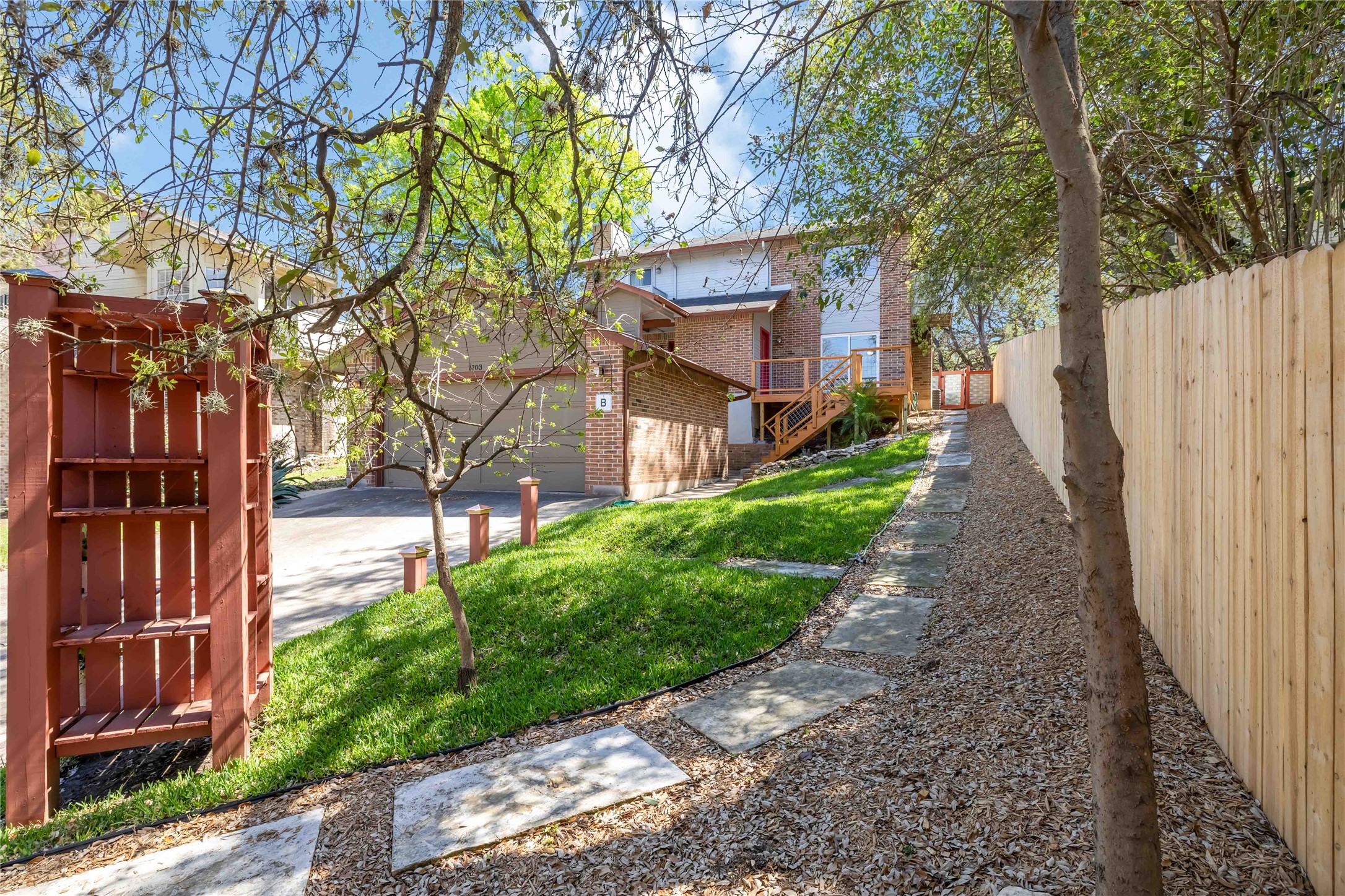 1703 Waterloo Trail, Unit B Austin, TX 78704 - Photo 3 of 36 View of yard featuring stairs and a wooden deck