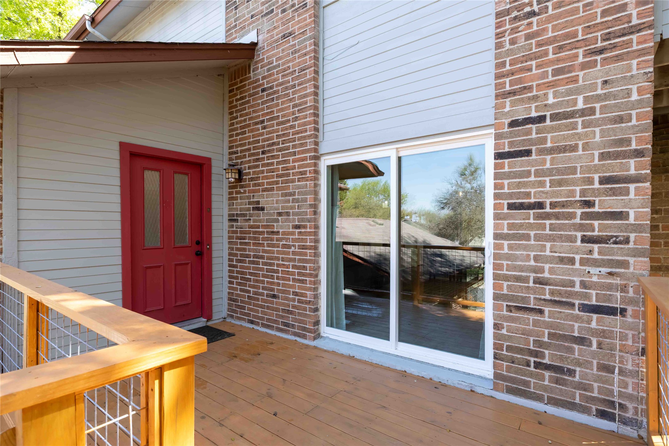 1703 Waterloo Trail, Unit B Austin, TX 78704 - Photo 32 of 36 Entrance to property with brick siding and a wooden deck