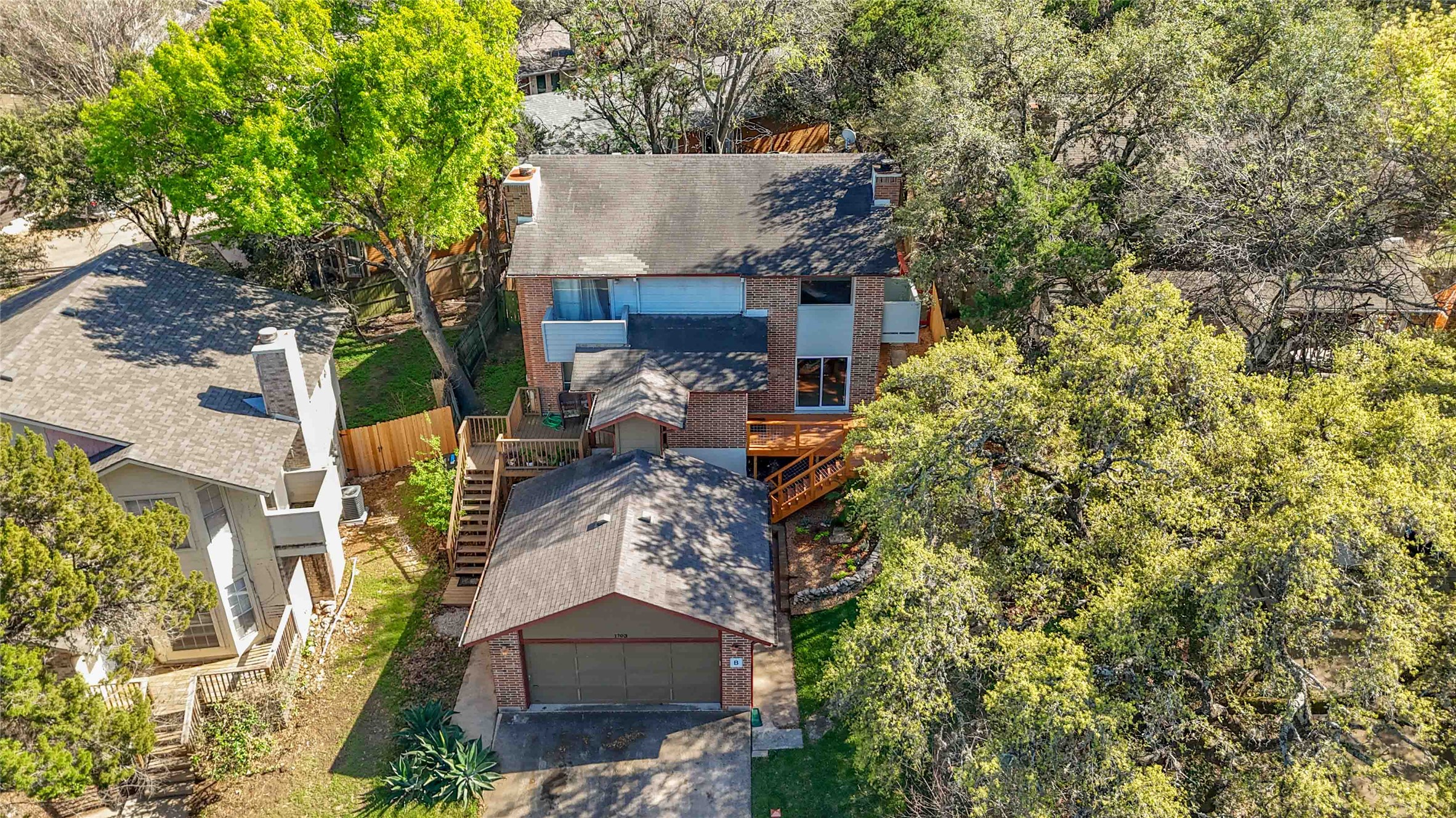 1703 Waterloo Trail, Unit B Austin, TX 78704 - Photo 33 of 36 Aerial view of property and surrounding area with a tree filled landscape
