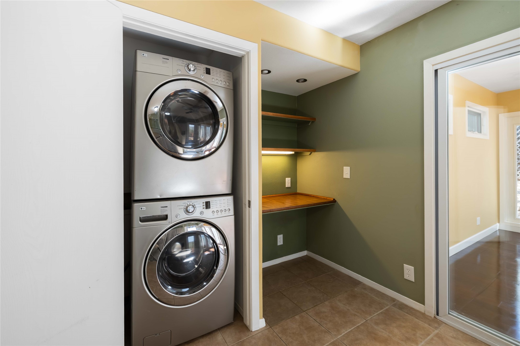 1703 Waterloo Trail, Unit B Austin, TX 78704 - Photo 10 of 36 Laundry area featuring stacked washer / dryer and light tile patterned floors