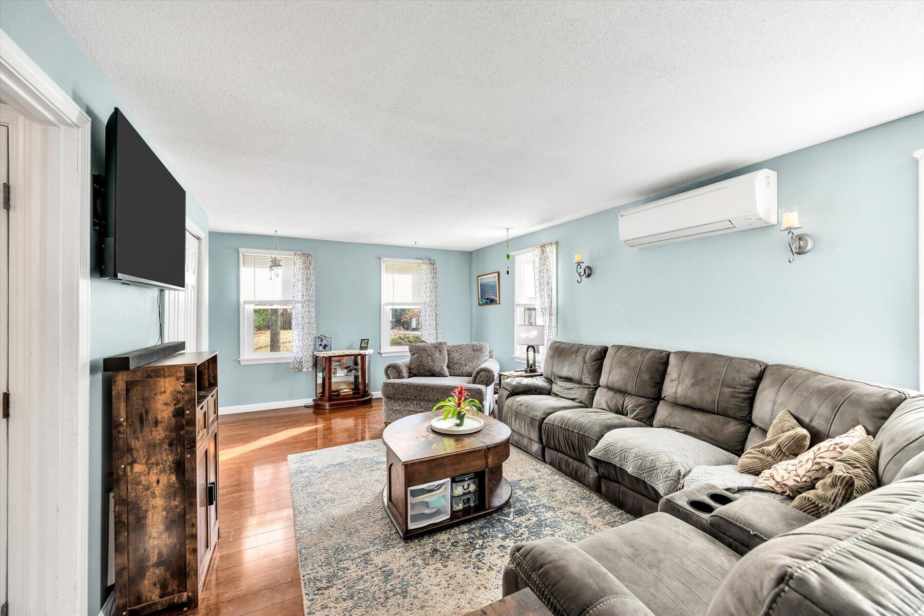 39 Papnomett Road Mashpee, MA 02649 - Photo 11 of 34 a living room with furniture and a flat screen tv