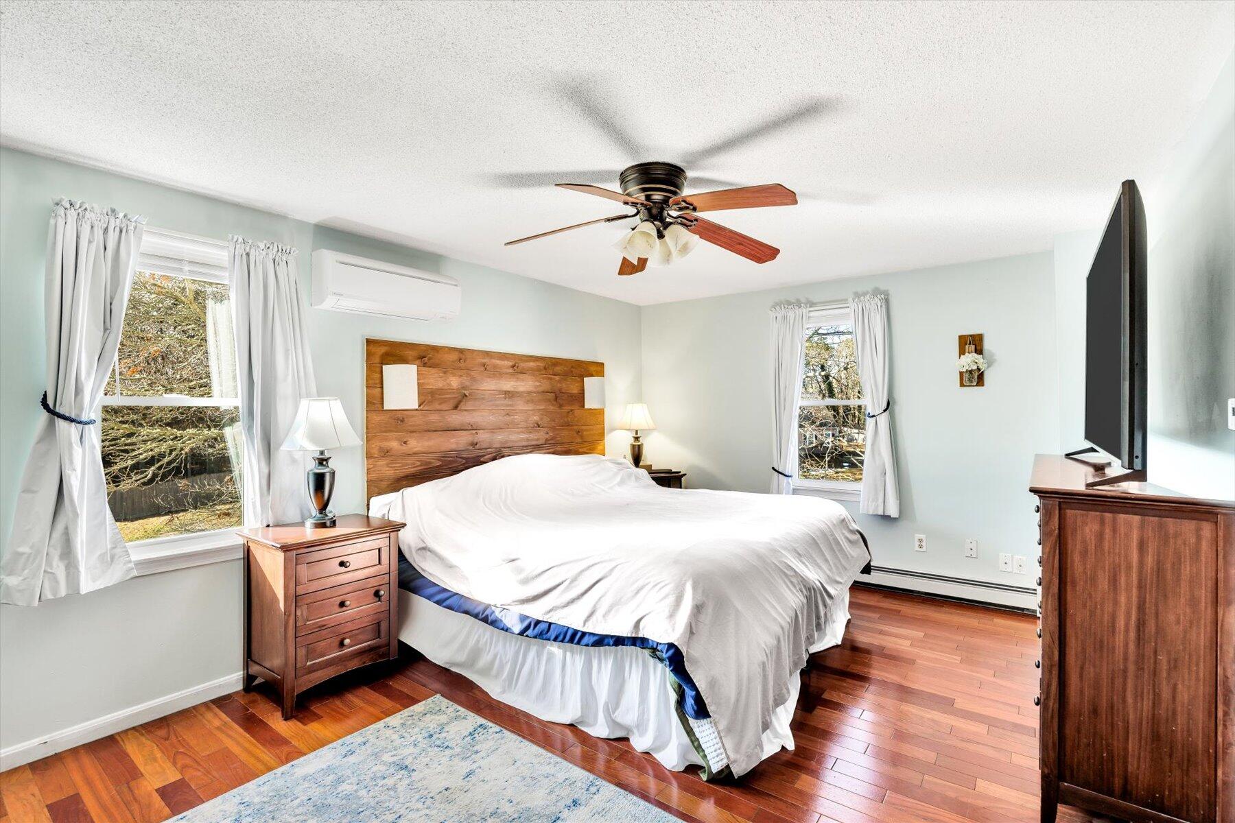 39 Papnomett Road Mashpee, MA 02649 - Photo 14 of 34 a bedroom with a bed dresser and wooden floor