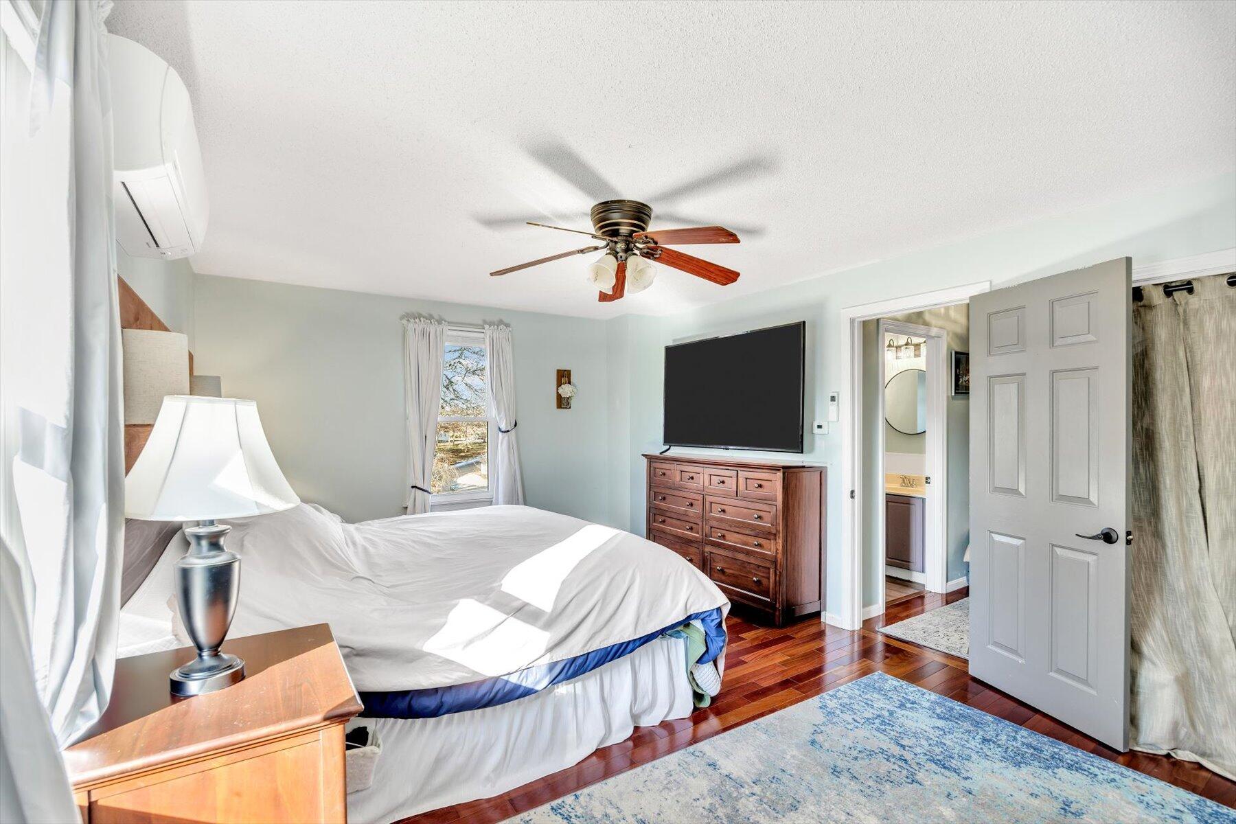 39 Papnomett Road Mashpee, MA 02649 - Photo 15 of 34 a bedroom with a bed and a flat screen tv