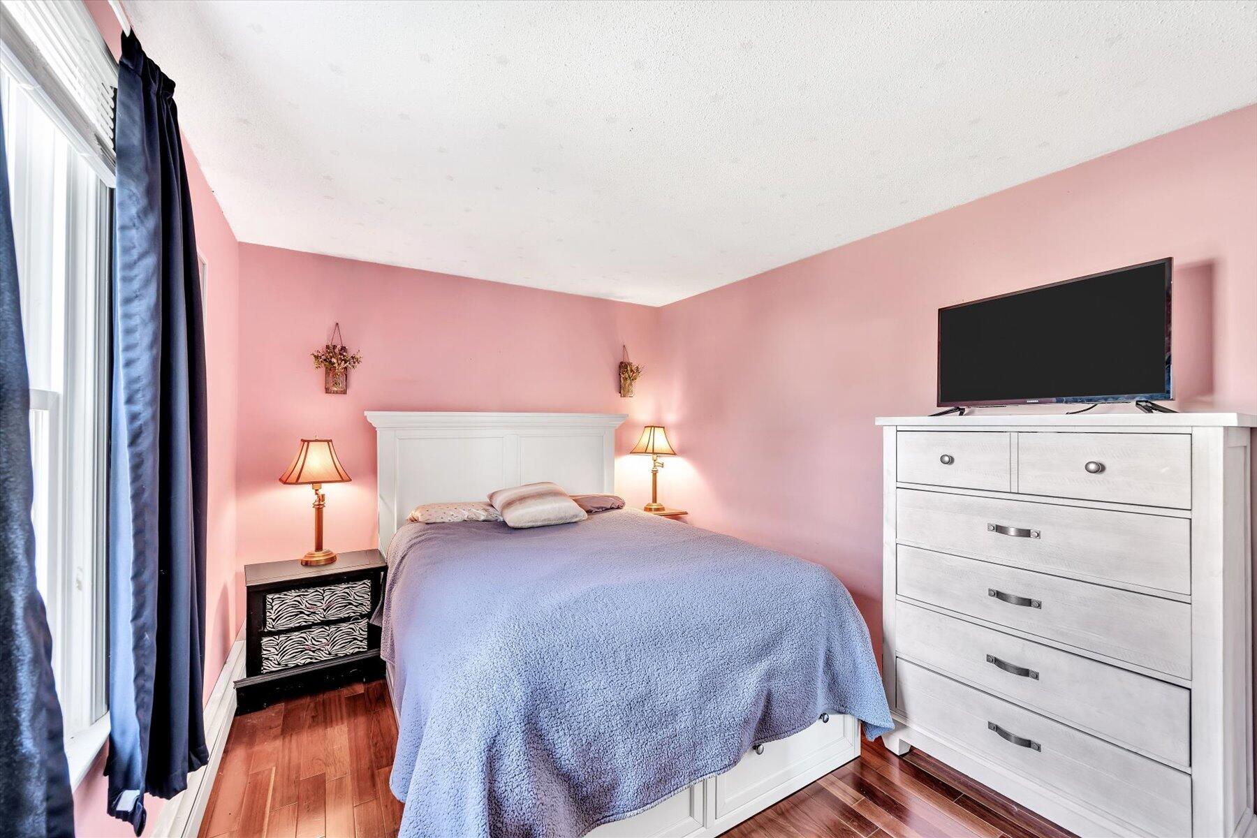 39 Papnomett Road Mashpee, MA 02649 - Photo 18 of 34 a bedroom with a bed and flat tv screen on dresser