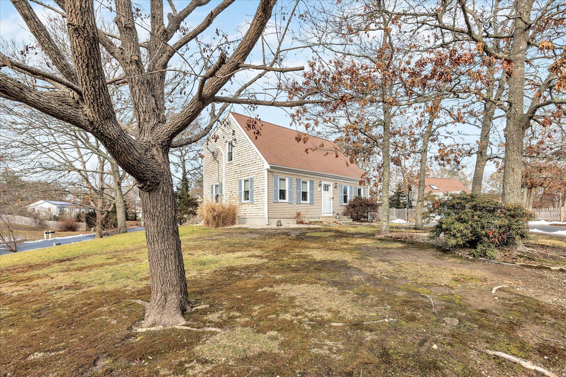39 Papnomett Road Mashpee, MA 02649 - Photo 2 of 34 a view of a yard with a tree in the yard