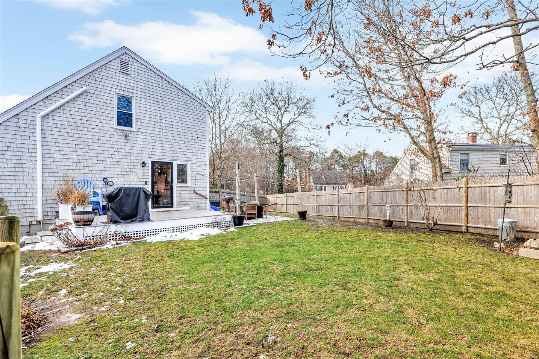 39 Papnomett Road Mashpee, MA 02649 - Photo 27 of 34 a view of a house with backyard and sitting area