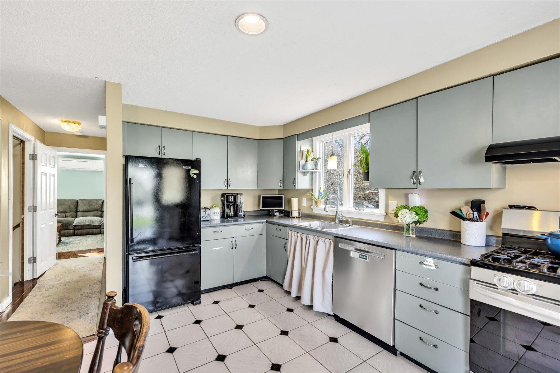 39 Papnomett Road Mashpee, MA 02649 - Photo 7 of 34 a kitchen with white cabinets and stainless steel appliances