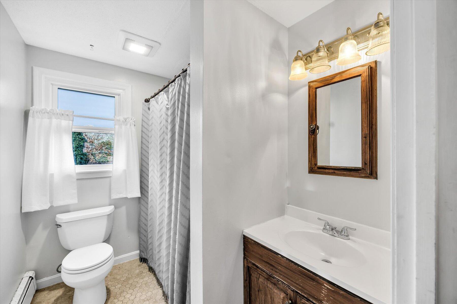 39 Papnomett Road Mashpee, MA 02649 - Photo 10 of 34 a bathroom with a sink a toilet and shower