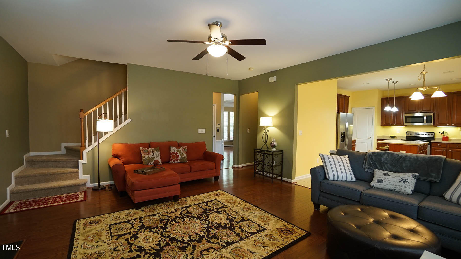3318 Colorcott Street Raleigh, NC 27614 - Photo 17 of 28 a living room with furniture ceiling fan and a rug