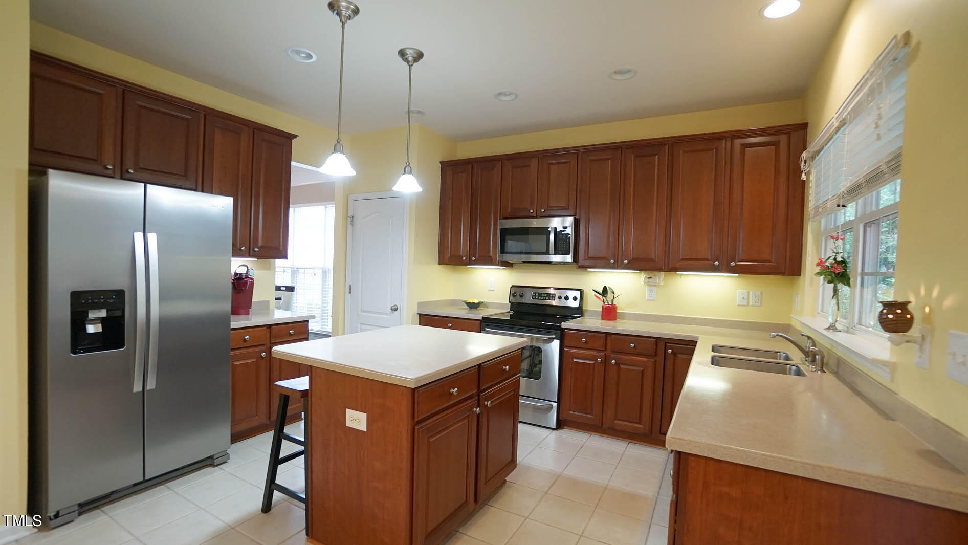 3318 Colorcott Street Raleigh, NC 27614 - Photo 19 of 28 a kitchen with stainless steel appliances granite countertop a sink a stove a refrigerator and cabinets