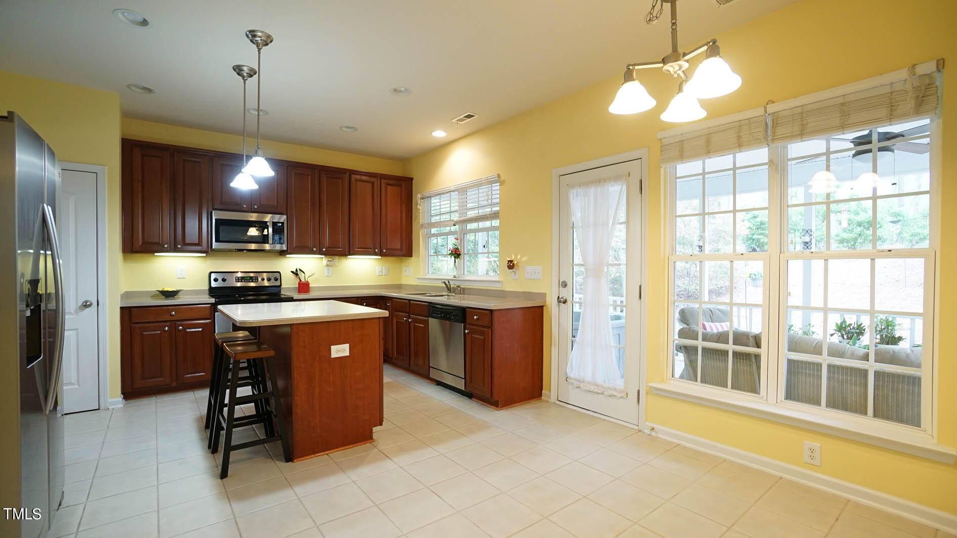 3318 Colorcott Street Raleigh, NC 27614 - Photo 20 of 28 a kitchen with stainless steel appliances granite countertop wooden cabinets a stove top oven a sink and dishwasher