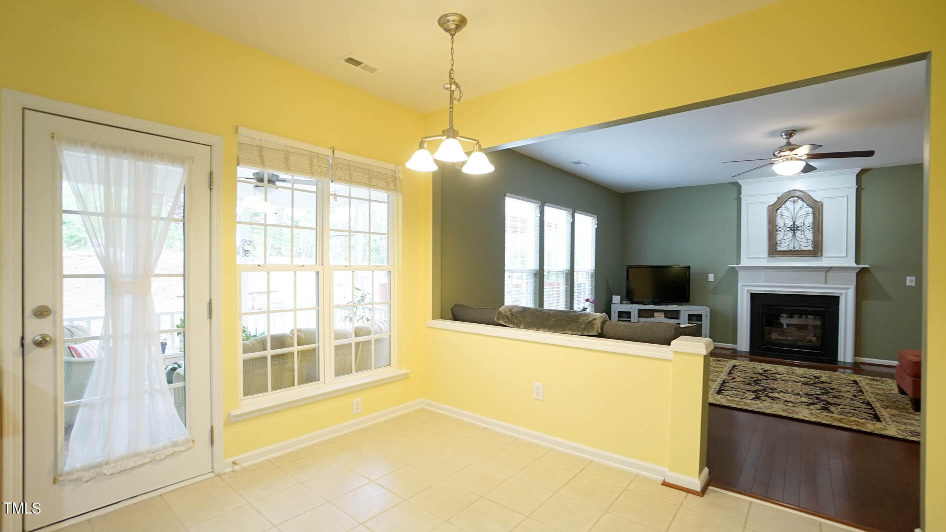 3318 Colorcott Street Raleigh, NC 27614 - Photo 21 of 28 a living room with furniture a fireplace and a flat screen tv
