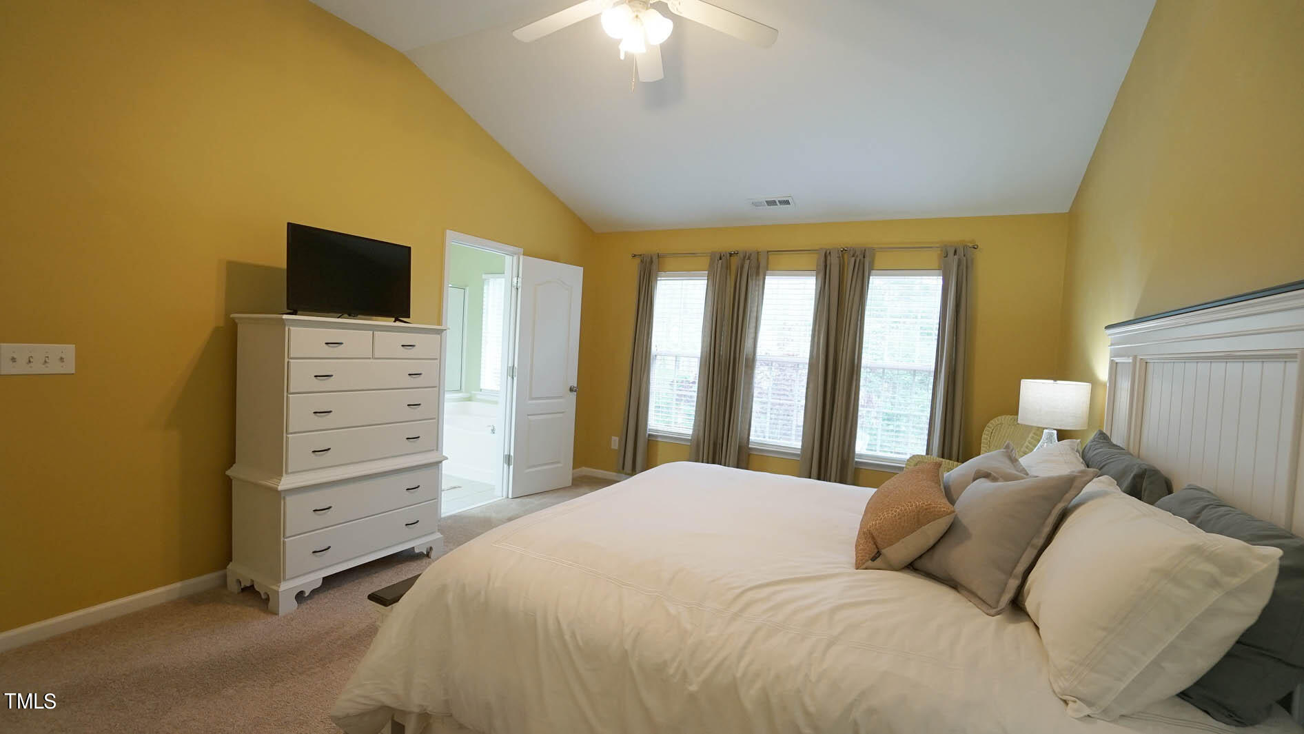 3318 Colorcott Street Raleigh, NC 27614 - Photo 23 of 28 a bedroom with a bed and a chandelier