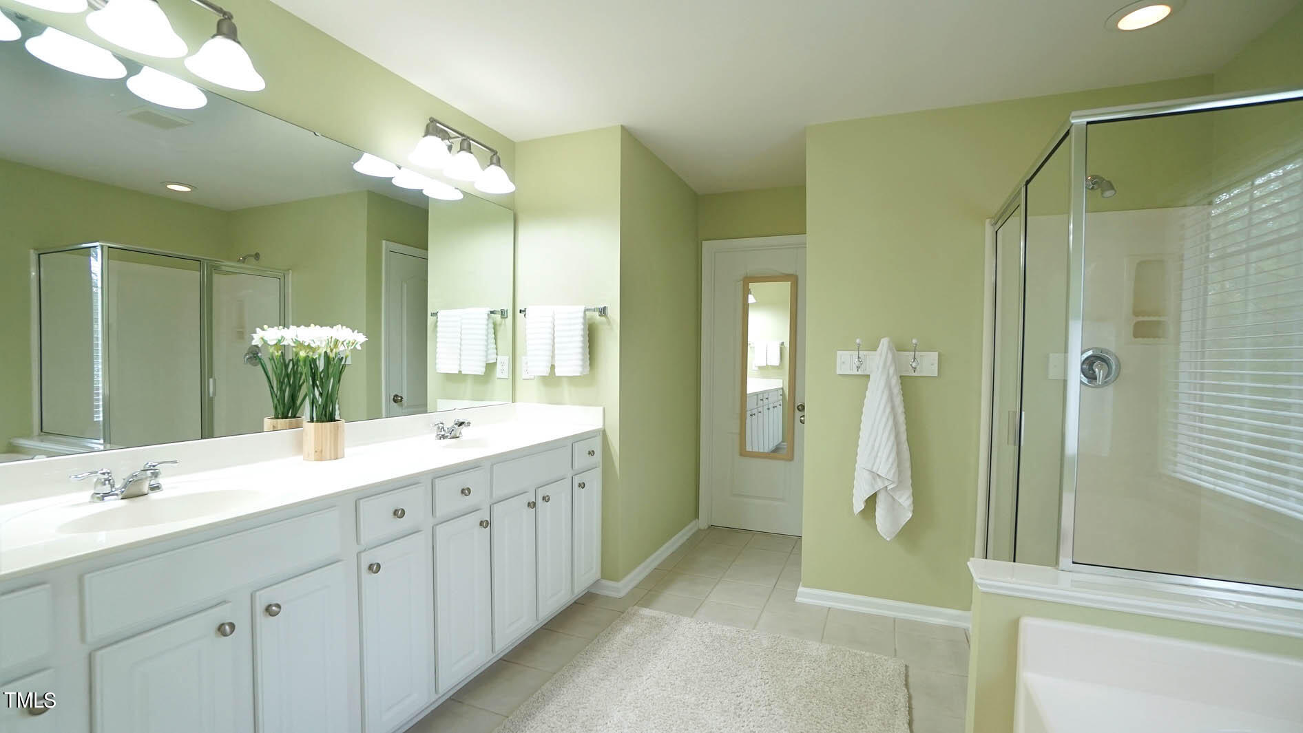 3318 Colorcott Street Raleigh, NC 27614 - Photo 24 of 28 a bathroom with a double vanity sink mirror and shower