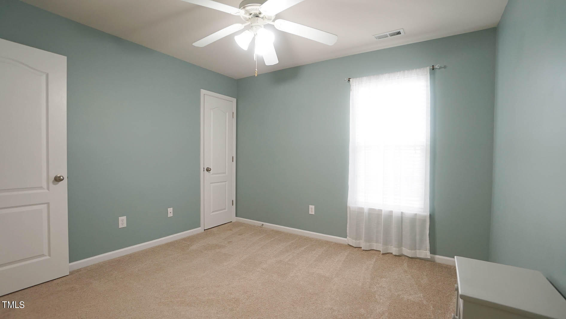 3318 Colorcott Street Raleigh, NC 27614 - Photo 26 of 28 an empty room with a ceiling fan and a window