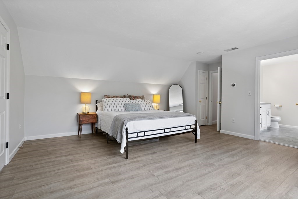 1 Sarah Lane Maynard, MA 01754 - Photo 17 of 40 a bedroom with a bed and wooden floor