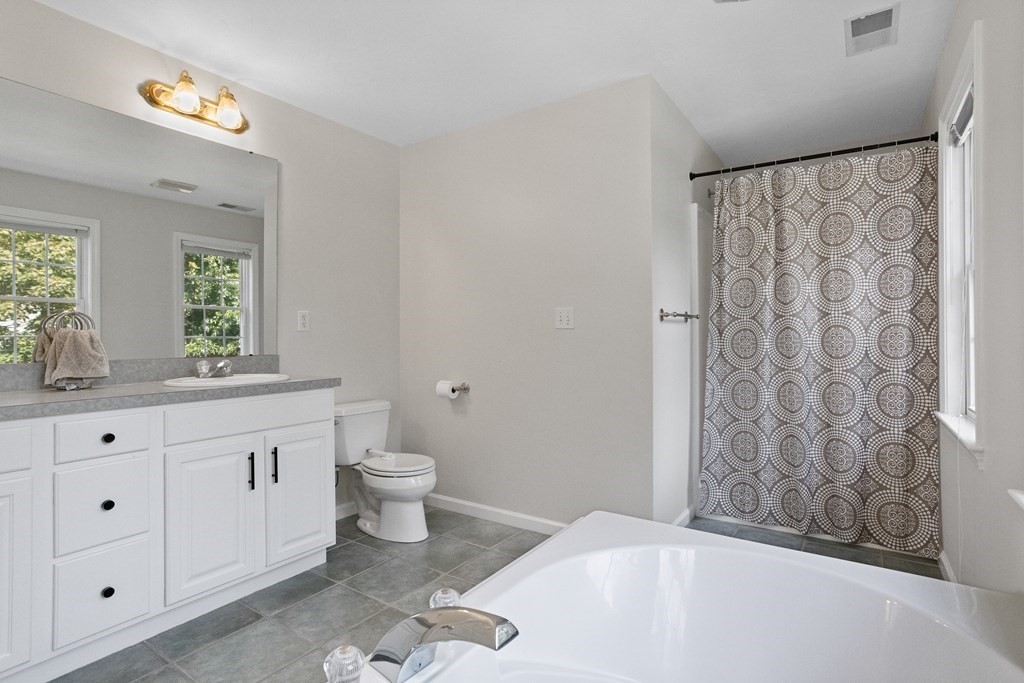 1 Sarah Lane Maynard, MA 01754 - Photo 18 of 40 a bathroom with a granite countertop sink a toilet and a bathtub
