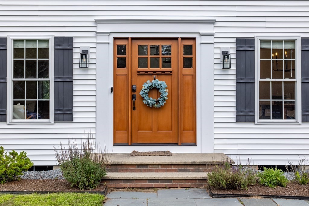 1 Sarah Lane Maynard, MA 01754 - Photo 2 of 40 a front view of a house with a garage
