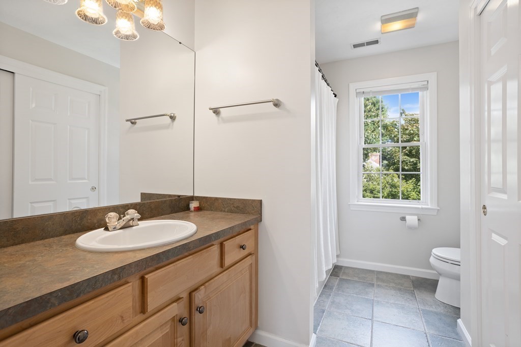 1 Sarah Lane Maynard, MA 01754 - Photo 25 of 40 a bathroom with a sink a toilet and a mirror