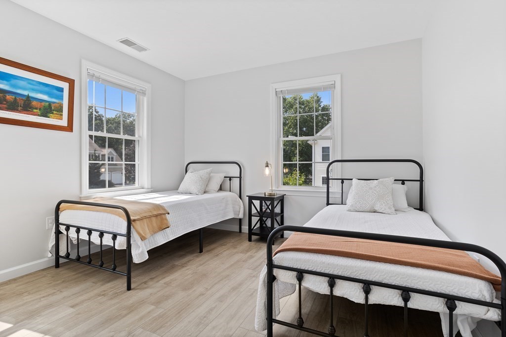 1 Sarah Lane Maynard, MA 01754 - Photo 26 of 40 a bedroom with a bed two lamps and a large window