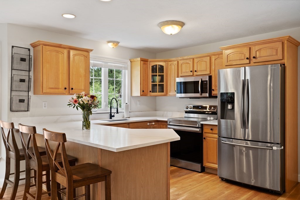 1 Sarah Lane Maynard, MA 01754 - Photo 3 of 40 a kitchen with granite countertop a refrigerator stove microwave and sink