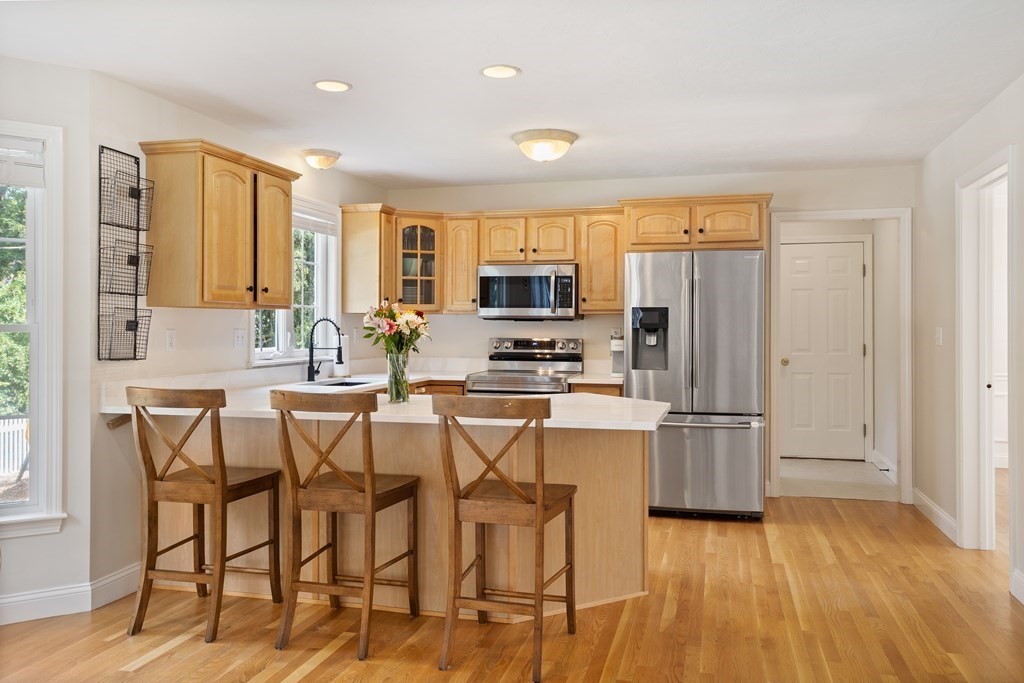 1 Sarah Lane Maynard, MA 01754 - Photo 4 of 40 a kitchen with stainless steel appliances a refrigerator and a stove top oven