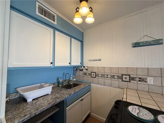 a kitchen with a sink and a stove