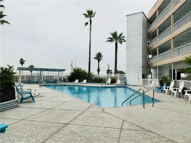 a view of a swimming pool with chairs