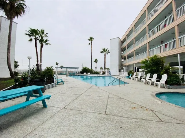 a swimming pool with outdoor seating and yard