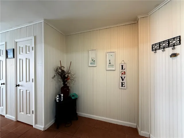 a view of a hallway with closet and front door