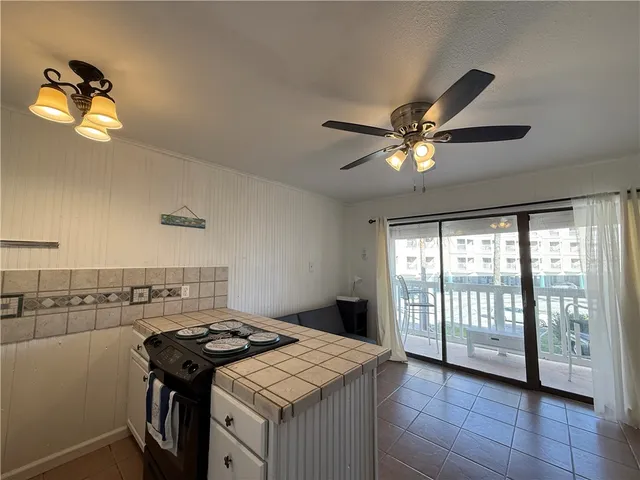 a kitchen with a stove a sink and a refrigerator