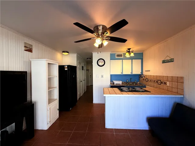 a kitchen with stainless steel appliances granite countertop a refrigerator a stove and a sink