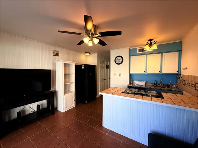 a kitchen with stainless steel appliances a stove a refrigerator and a microwave