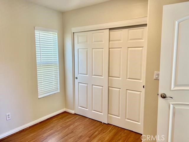 14566 Rochester Avenue Chino, CA 91710 - Photo 16 of 33 an empty room with wooden floor and windows