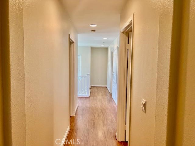 14566 Rochester Avenue Chino, CA 91710 - Photo 20 of 33 a view of a hallway with wooden floor