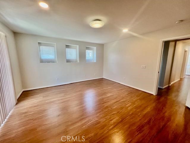 14566 Rochester Avenue Chino, CA 91710 - Photo 22 of 33 an empty room with wooden floor and entrance