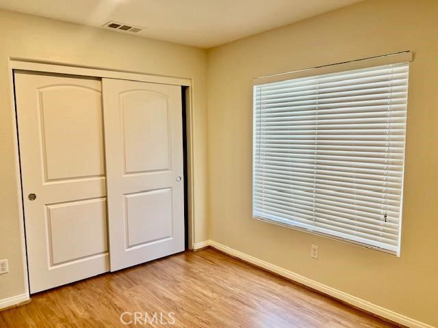 14566 Rochester Avenue Chino, CA 91710 - Photo 26 of 33 a view of an empty room with wooden floor and a window