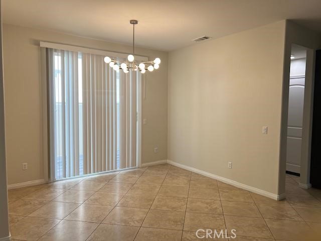 14566 Rochester Avenue Chino, CA 91710 - Photo 3 of 33 a view of an empty room with chandelier and window
