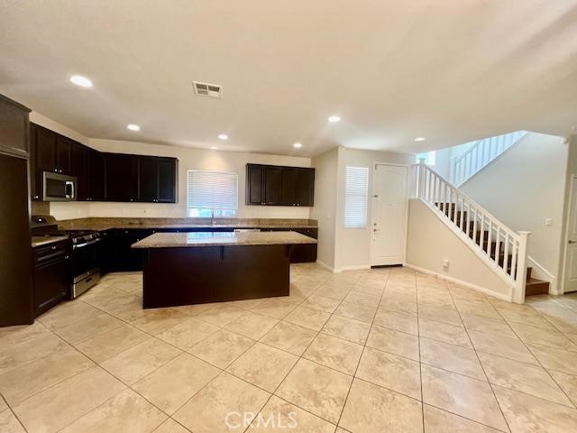 14566 Rochester Avenue Chino, CA 91710 - Photo 5 of 33 a large kitchen with stainless steel appliances granite countertop a sink and a stove