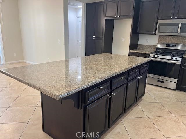 14566 Rochester Avenue Chino, CA 91710 - Photo 10 of 33 a kitchen with granite countertop a sink a stove and refrigerator