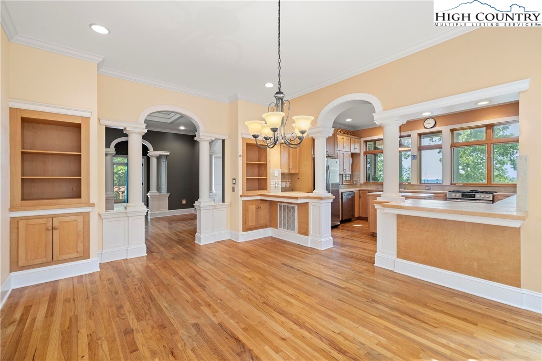 461 Summit Rise Drive Boone, NC 28607 - Photo 12 of 50 a kitchen with stainless steel appliances kitchen island granite countertop a sink cabinets and wooden floor