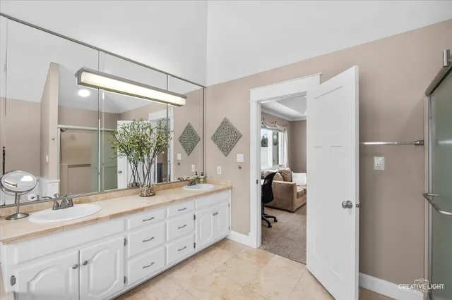 a bathroom with a double vanity sink and a mirror